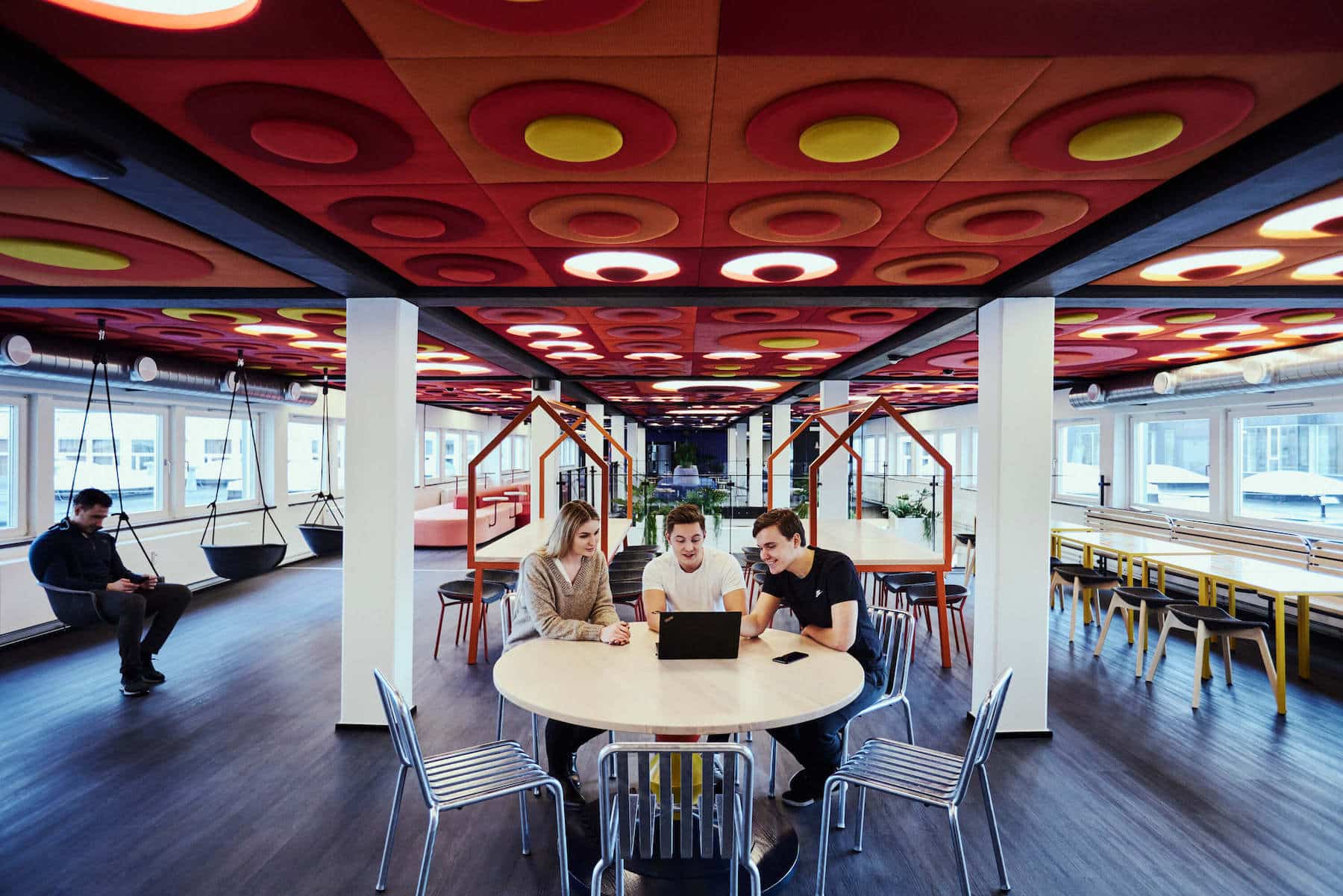 A group of students doing university work in the spacious and modern study area of Basecam Copenhagen South Campus accommodation