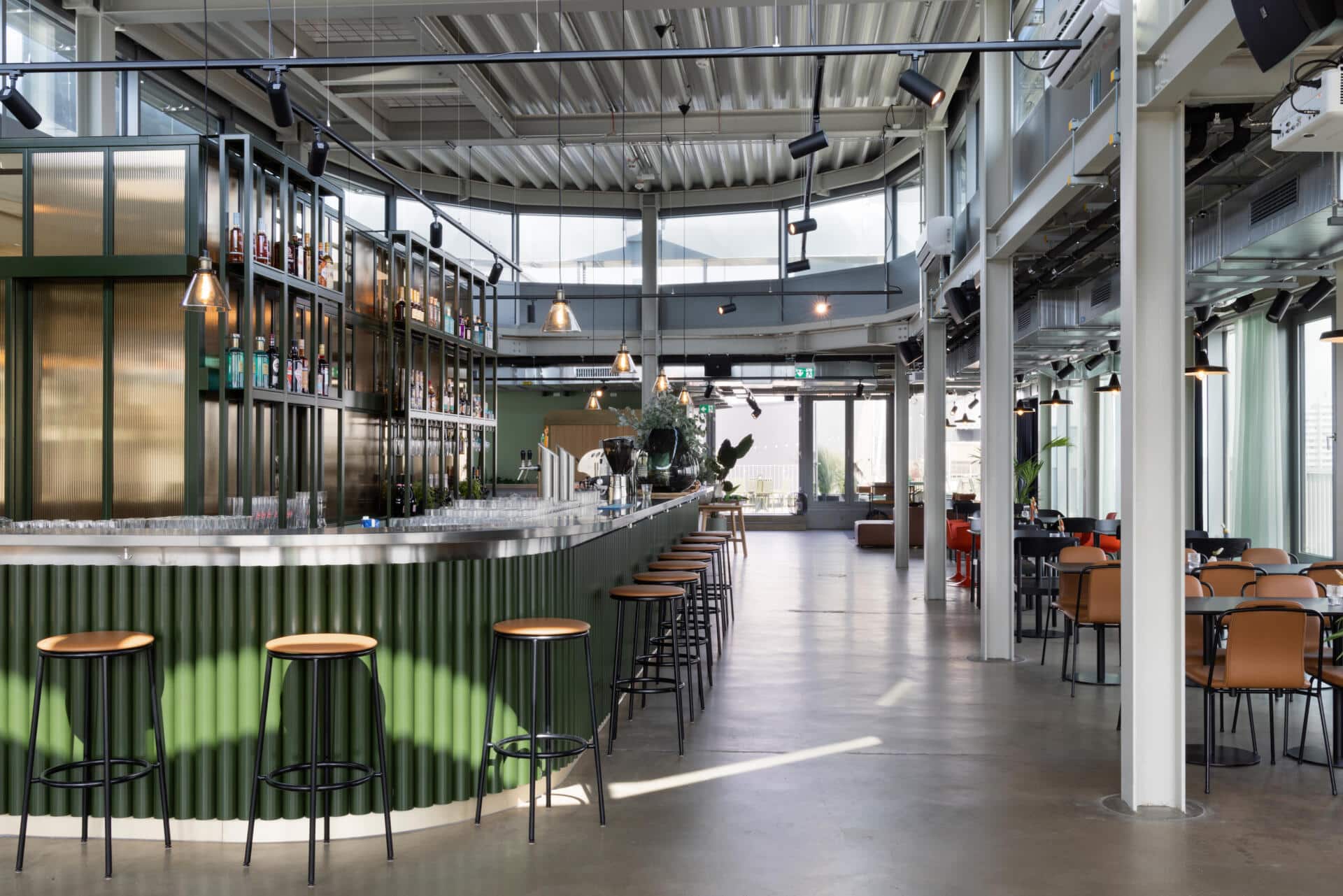 Basecamp Dortmund Hotel's bar and restaurant area with a modern and industrial design