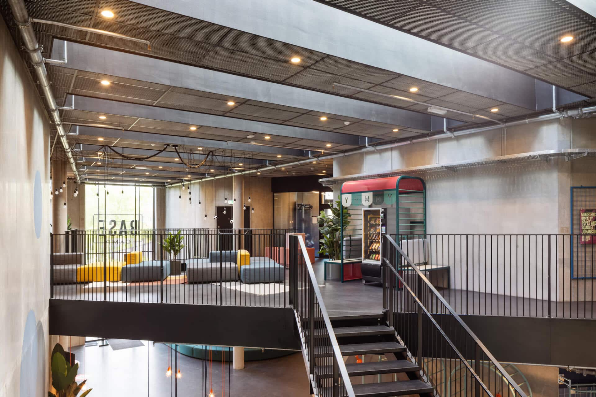 Sofas and a vending machine in a communcal space at Basecamp Lyngby student accommodation