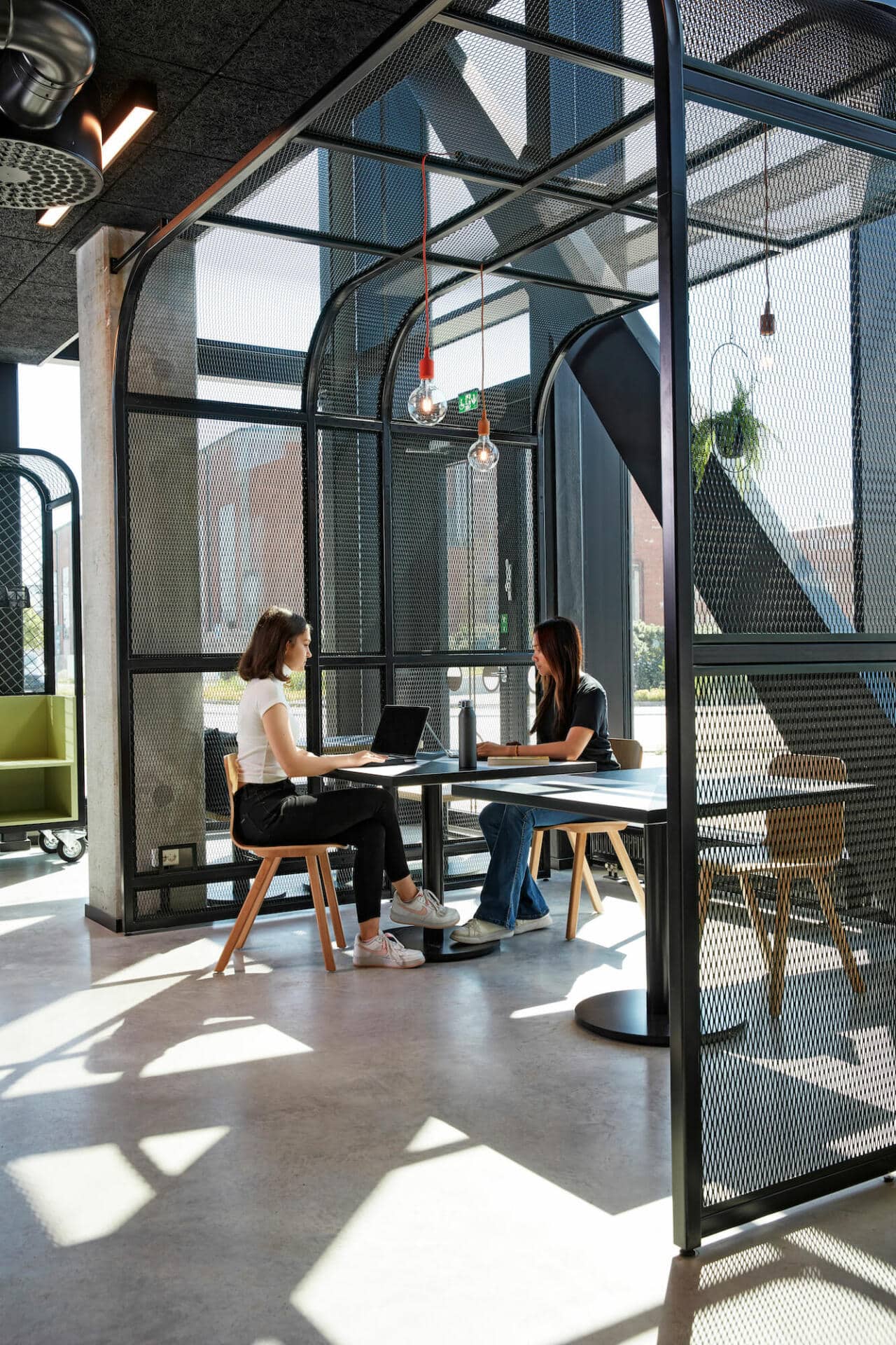 two girls doing university work in the communal study area at Basecamp Malmö student accommodation