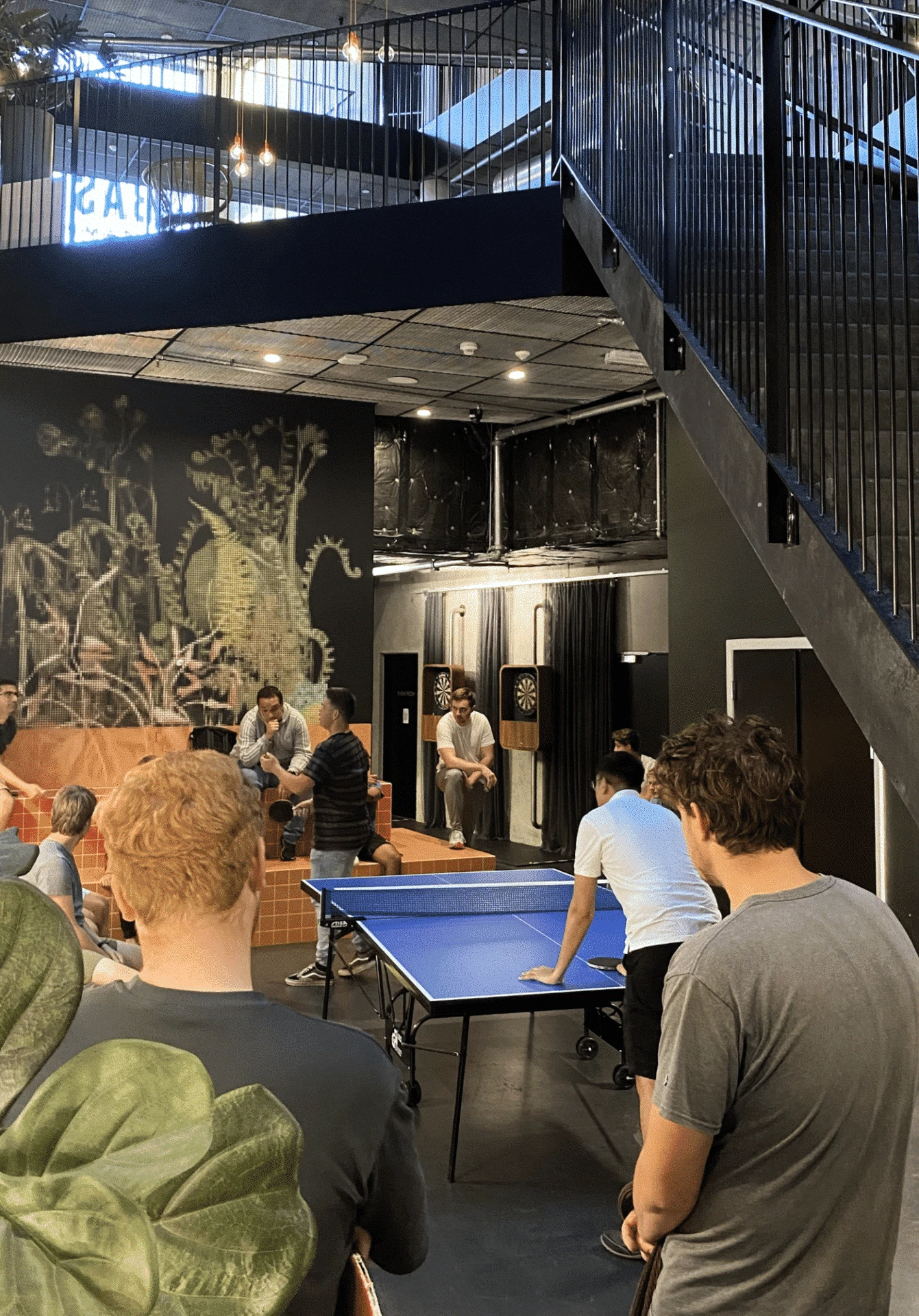 students play pingpong in a common area of Basecamp Lyngby student accommodation