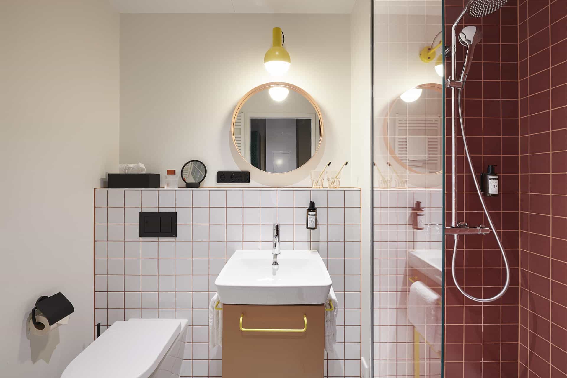 Bathroom with white and red walls in a room at Basecamp Dortmund Hotel