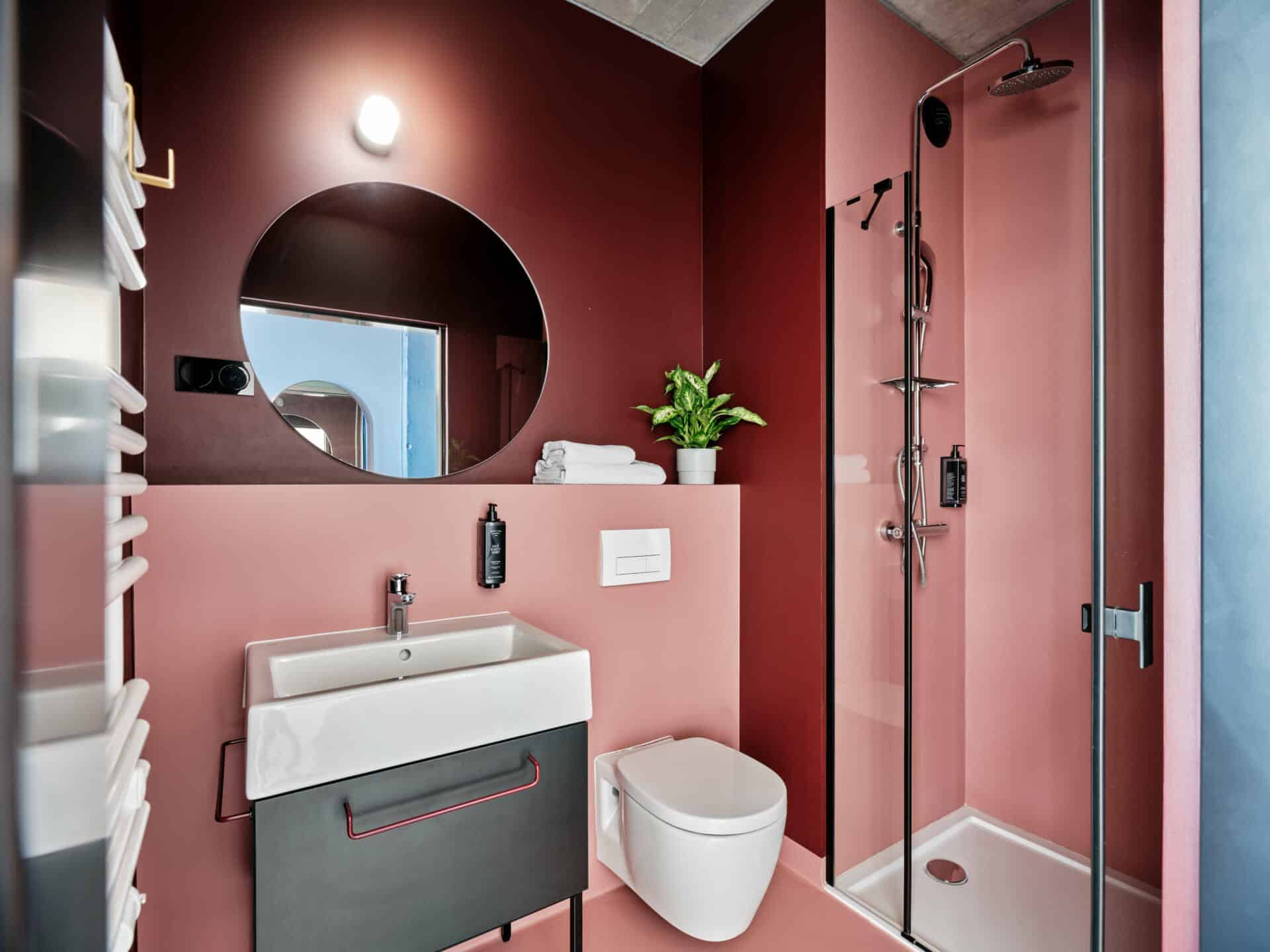 Sink and shower in the private bathroom of a student room at Basecamp Wroclaw dormitory