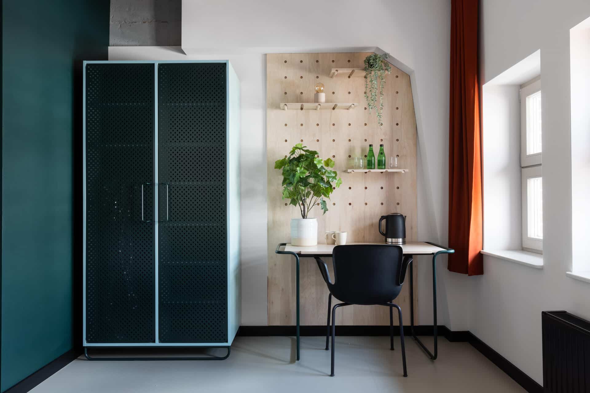 Wardrobe and desk in hotel room at Basecamp Wrocław